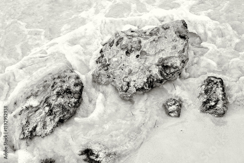 Water Swirling Around Stones on the Beach