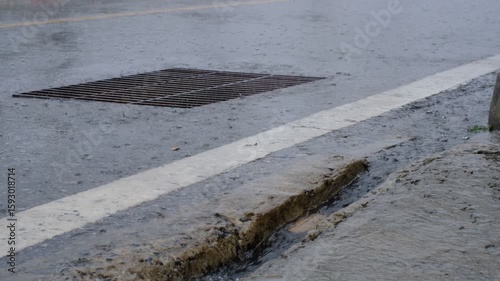 Wallpaper Mural A street with a grate in the middle and a white line on the side. The street is wet and muddy Torontodigital.ca