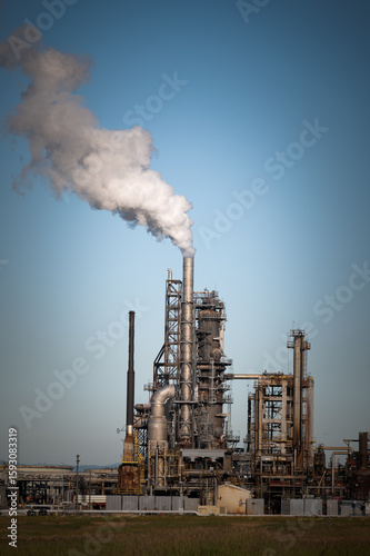 Oil Refinery With Steam Streaming out of the Stack. Oil refinery producing petroleum products in the Pacific Northwest. 