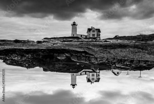 Canvas Print Black and white reflective image of the Nubble lighthouse