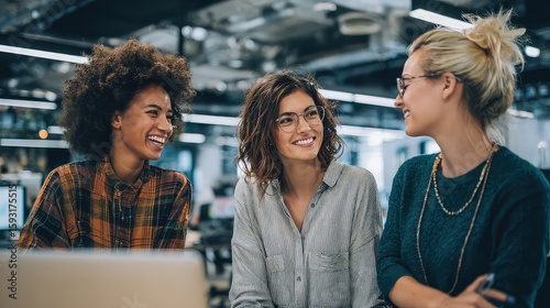 Happy women employees collaborating in a modern office