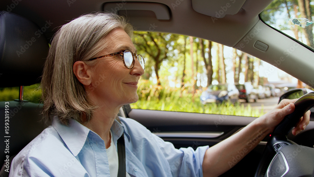 Naklejka premium Carefree active Caucasian pensioner positive owner elderly woman buyer senior mature female auto driver riding inside automobile driving vehicle dancing music song enjoying good quality audio radio