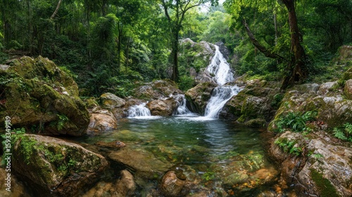 Lush waterfall cascading into a tranquil pool amidst a dense, verdant forest