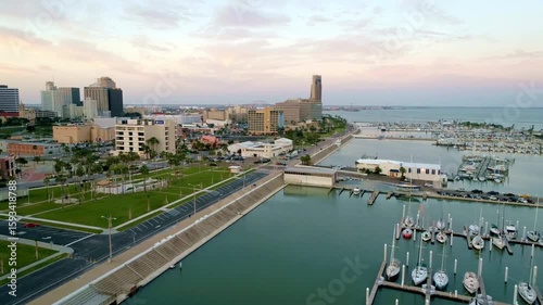 Aerial view of corpus christi skyline at dusk with marina and boats