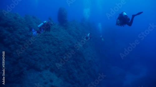 Wallpaper Mural scubadivers are exploring the reefs and topography underwater Torontodigital.ca