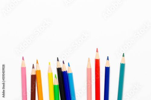 Collection of colorful sharpened pencils on a white background with copy space.