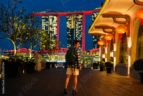 Canvas Print Man with a backpack walking on a wooden path in Gardens by the Bay, Singapore, w