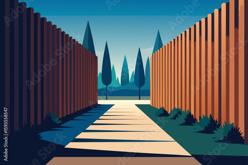 Path between wooden fences leading to tall trees
