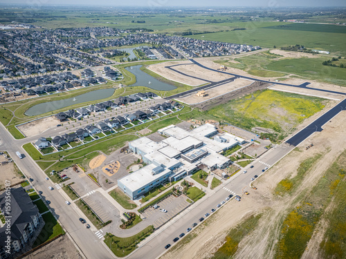 Large school campus with a lot of parking lots and houses in the background