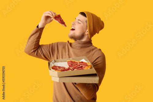 Young man eating piece of t...