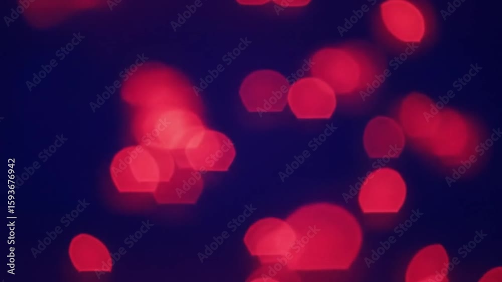 Abstract background with red bokeh light bubbles rising smoothly from bottom to top. Soft glowing orbs with a dynamic, flowing motion, creating a vibrant and energetic atmosphere.