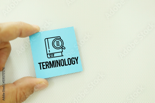 magnifying glass, glasses, pen and colored paper with the word TERMINOLOGY