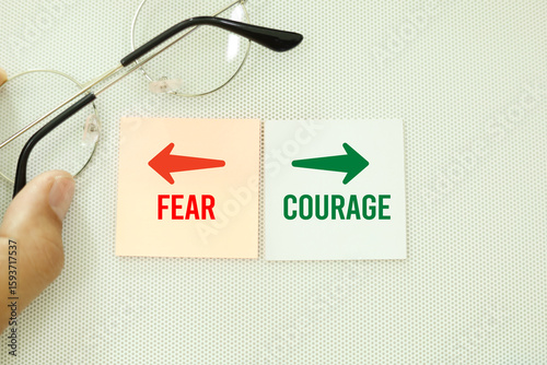 Two opposite words Direction Way to Courage vs Fear. Courage isn't the absence of fear, but rather the ability to act despite it