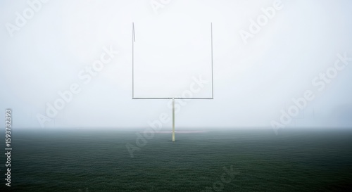 American Football Goalposts Stand Tall on a Foggy Field Ready for Action