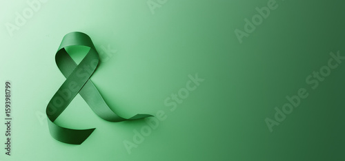 green awareness ribbon on gradient background