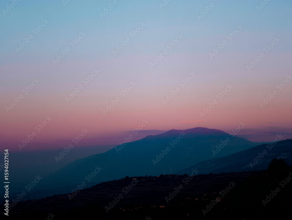Obraz premium pink sky, gradient upper black,shadow of a mountain in the center