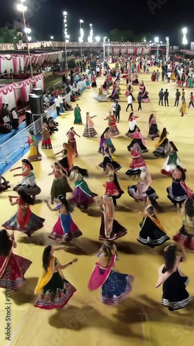 Navratri Garba night in Gujarat — women in colorful lehengas dancing in circles, top-down drone view, energetic beats, sparkling lights everywhere