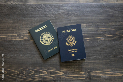 Mexican and American passports. Two passports with dark wooden background.