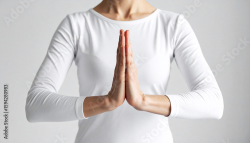 a yoga practitioner's hands in prayer position, centered against a neutral background. Minimalist style with calm energy, symbolizing balance, mindfulness, and inner peace