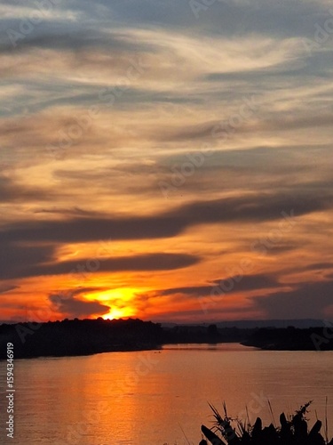 Beautiful golden sky by the sunset over the river in Laos