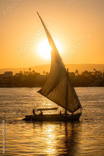 фотографія Sunset on the Nile River with Feluccas in Luxor, Egypt