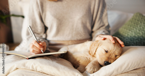 Bild auf Leinwand Owner, sleeping and writing with puppy on lap of person in bedroom of home for bonding or relax