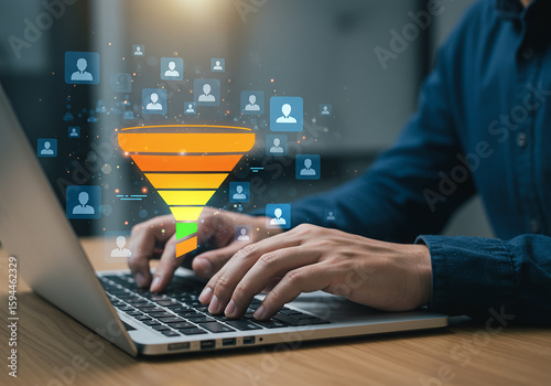 Person using laptop with a digital sales funnel and customer icons