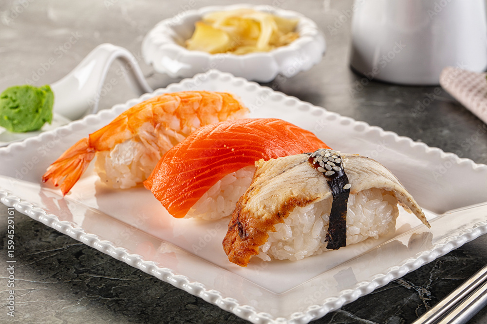 Japanese cuisine - sushi with eel, salmon and prawn Japanese cuisine - sushi with eel, salmon and prawn