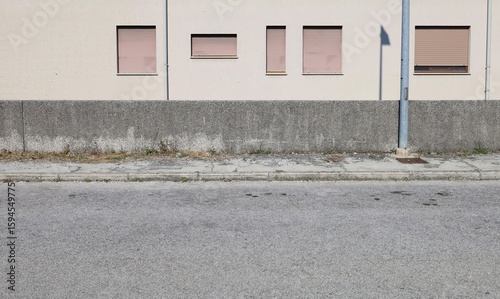 Wallpaper Mural Concrete fence with beige condominium facade on behind. Cement sidewalk and urban street in front. Background for copy space. Torontodigital.ca