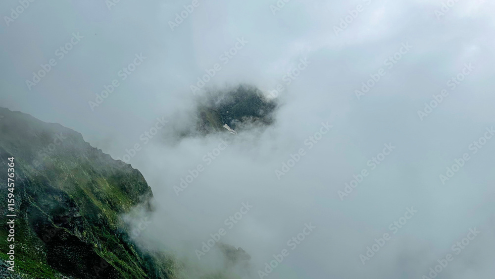 Fototapeta premium Foggy Mountains with Hidden Green Cliffs