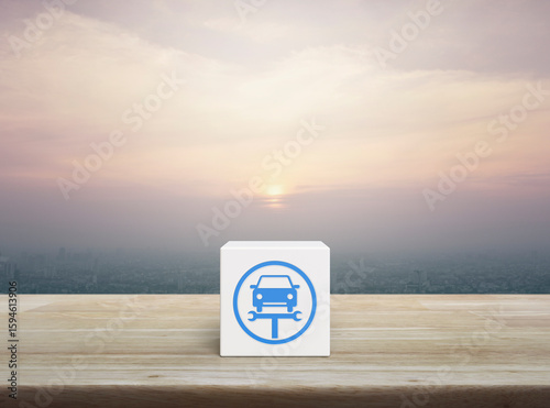 Service fix car with wrench tool flat icon on white block cube on wooden table over modern city tower and skyscraper at sunset, vintage style, Business repair car service concept