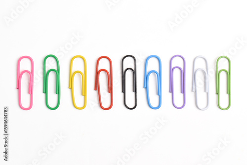 Set with colorful paper clips isolated on white background, top view