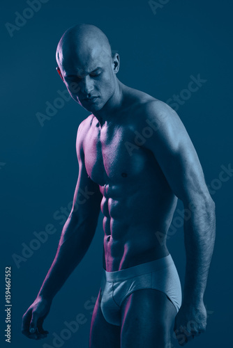 Quadro su tela Muscular man in black and white lighting, exuding strength and determination with a focused expression, showcasing the beauty of the human physique