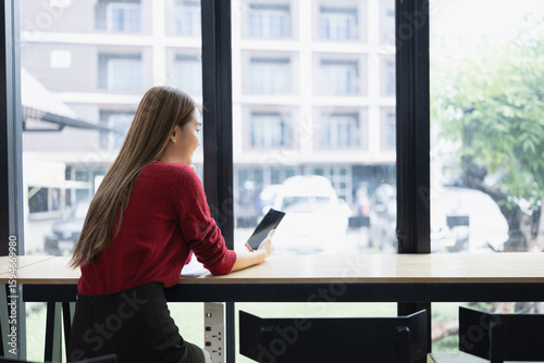 Happy young Asian businesswoman using digital smartphone sitting in office. Free Download Happy young Asian businesswoman using digital smartphone sitting in office. - GFXLoad