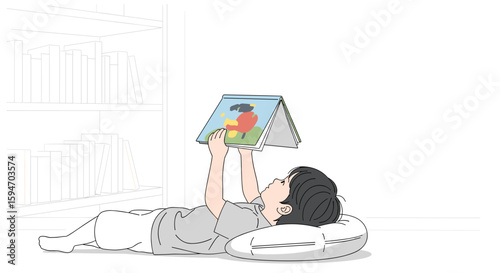  Young boy lying and reading picture book on white background