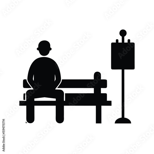 Black silhouette of a street artist painting on a bench in an urban setting
