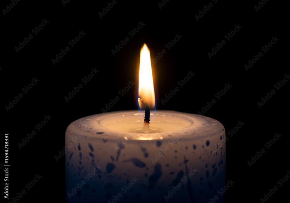 single white candle burning with bright flame against dark background
single white candle burning with bright flame against dark background