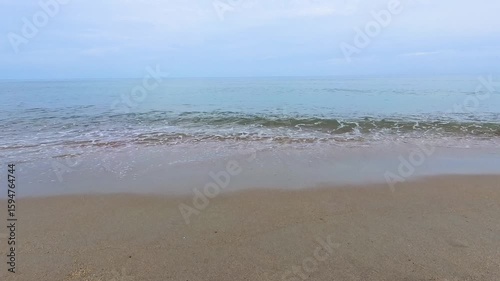 Scenic of seascape with sand and wave on the beach in evening skyline for relaxing time.