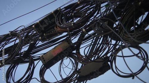 A Complex Network of Intricate Wires Framed Beautifully Against the Expansive Clear Sky Above Us