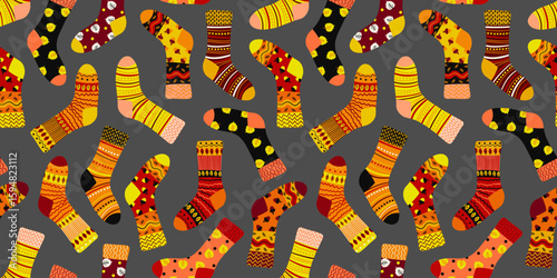 warm autumn socks seamless pattern on a dark grey background cozy footwear design for fall season textiles and fashion