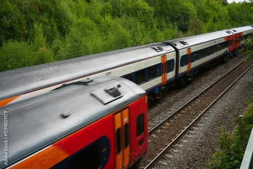 Codnor, Derbyshire, England – July 16 2025: High speed passenger train traveling through lush green countryside