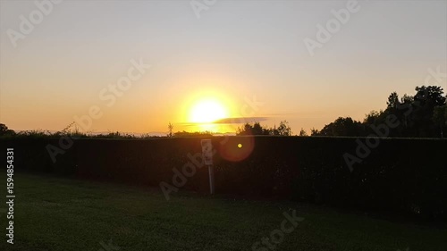 Sunset or sunrise in the countryside with trimmed hedges in front