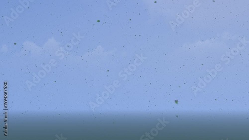 Dynamic abstract background featuring small green and dark particles falling against a blue sky with faint clouds. Usable as a natural overlay, texture, or environmental effect.
