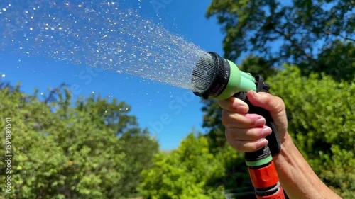 Watering the garden with a hosepipe - water shortage - hosepipe ban