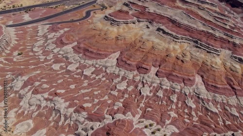 Desert Highway Cutting Through Vibrant Geological Formations in Arid Terrain