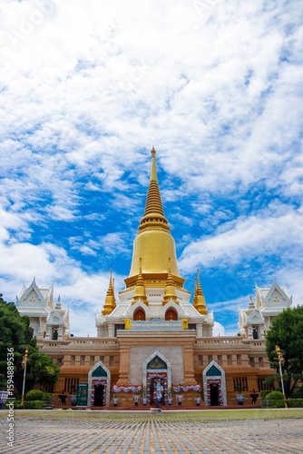 Grand Golden Pagoda at Thai Temple Entrance under Bright Sky