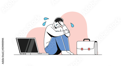 Depressed businessman feeling stress and anxiety sitting on the floor next to his briefcase and laptop