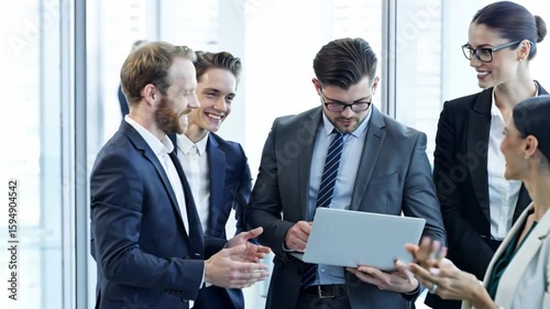 Diverse business professionals confidently discuss a project in a modern office setting.