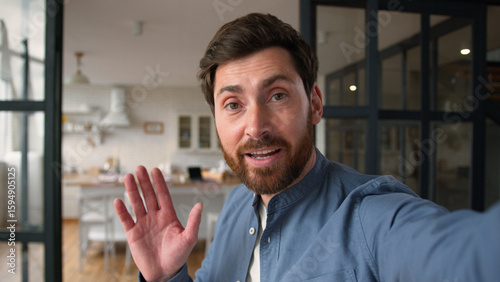 Tableau sur toile Glad Caucasian man male father smiling recording video blog speaking camera mobi