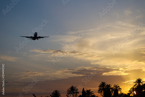 Plane flying with clearly sky at sunset